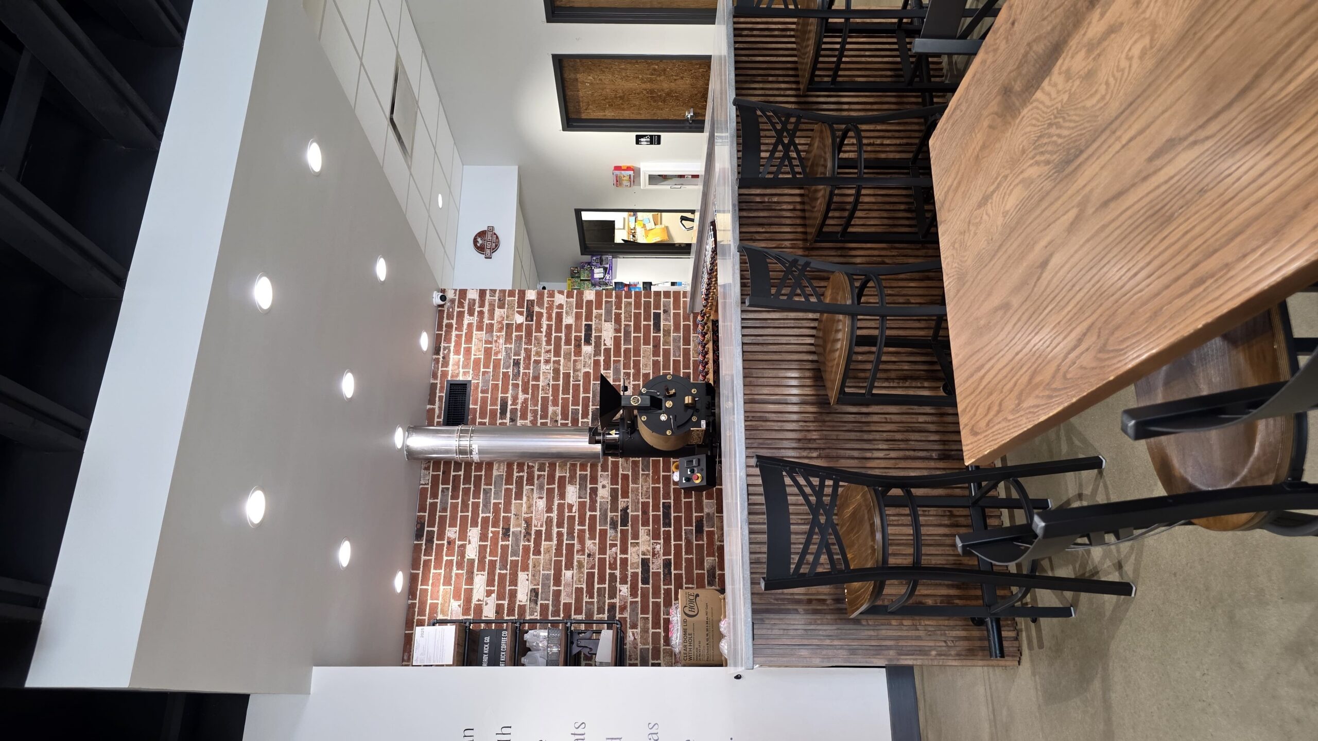 Coffee roasting area and nearby seating inside Goat Kick Coffee