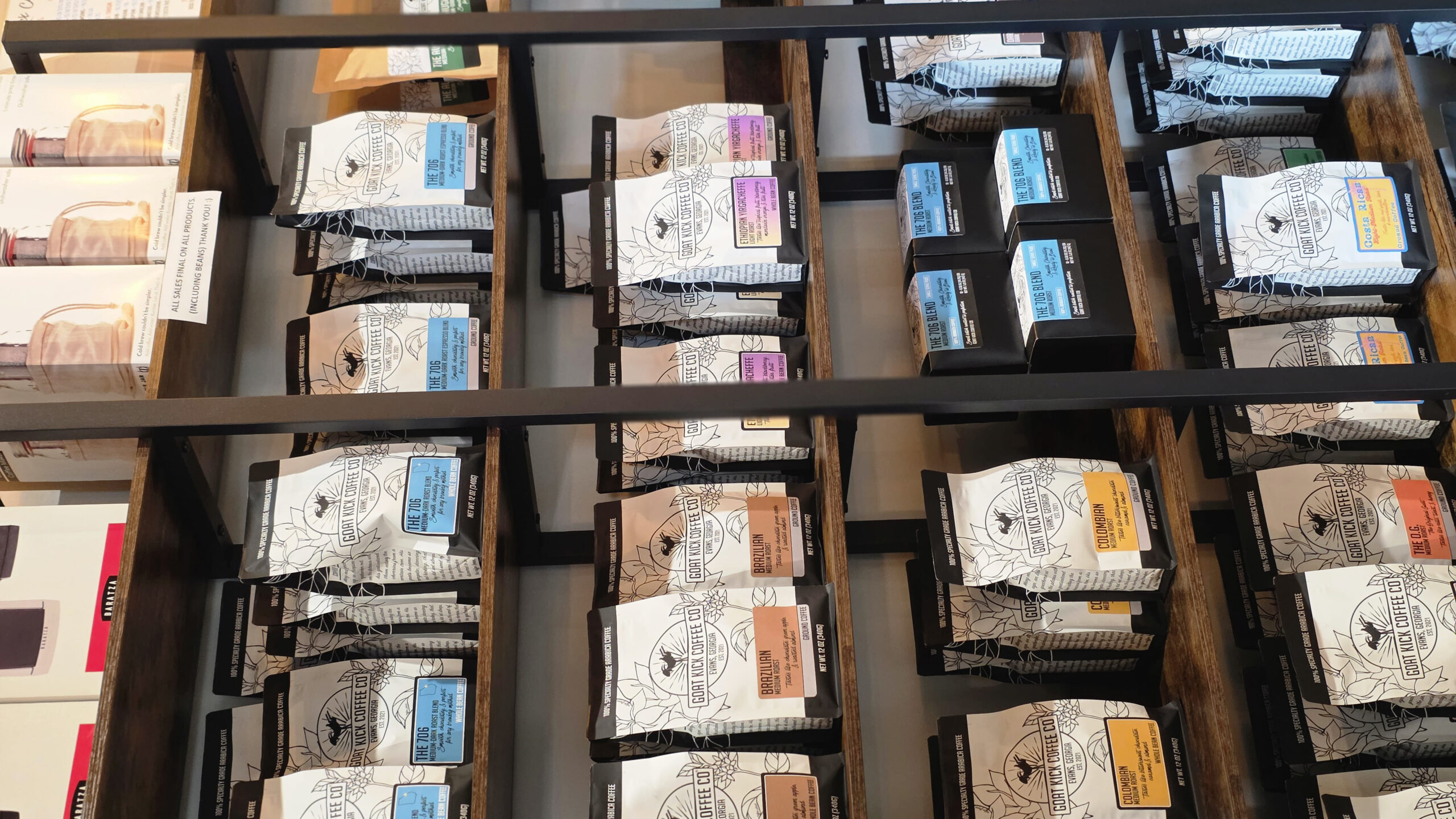 Retail display of Goat Kick Coffee whole bean coffee bags in Evans, Georgia