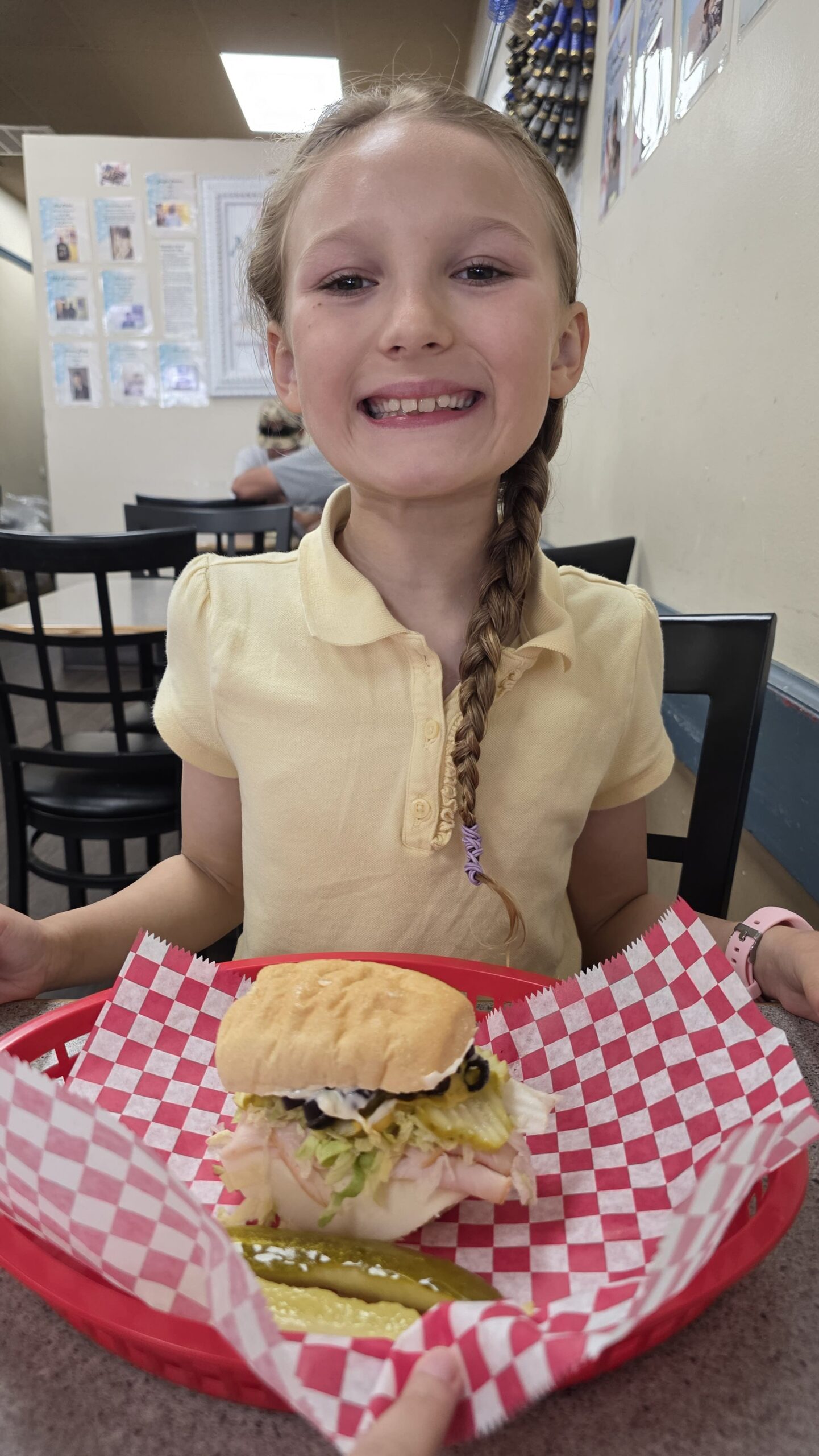 Child enjoying a sandwich at Just Julie’s Sandwich Shop in Aiken
