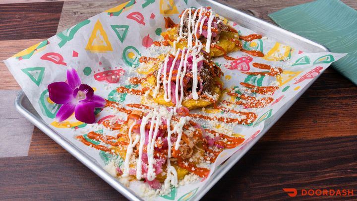 Colorful Latin American dish finished with sauces and fresh garnishes at El Tejano