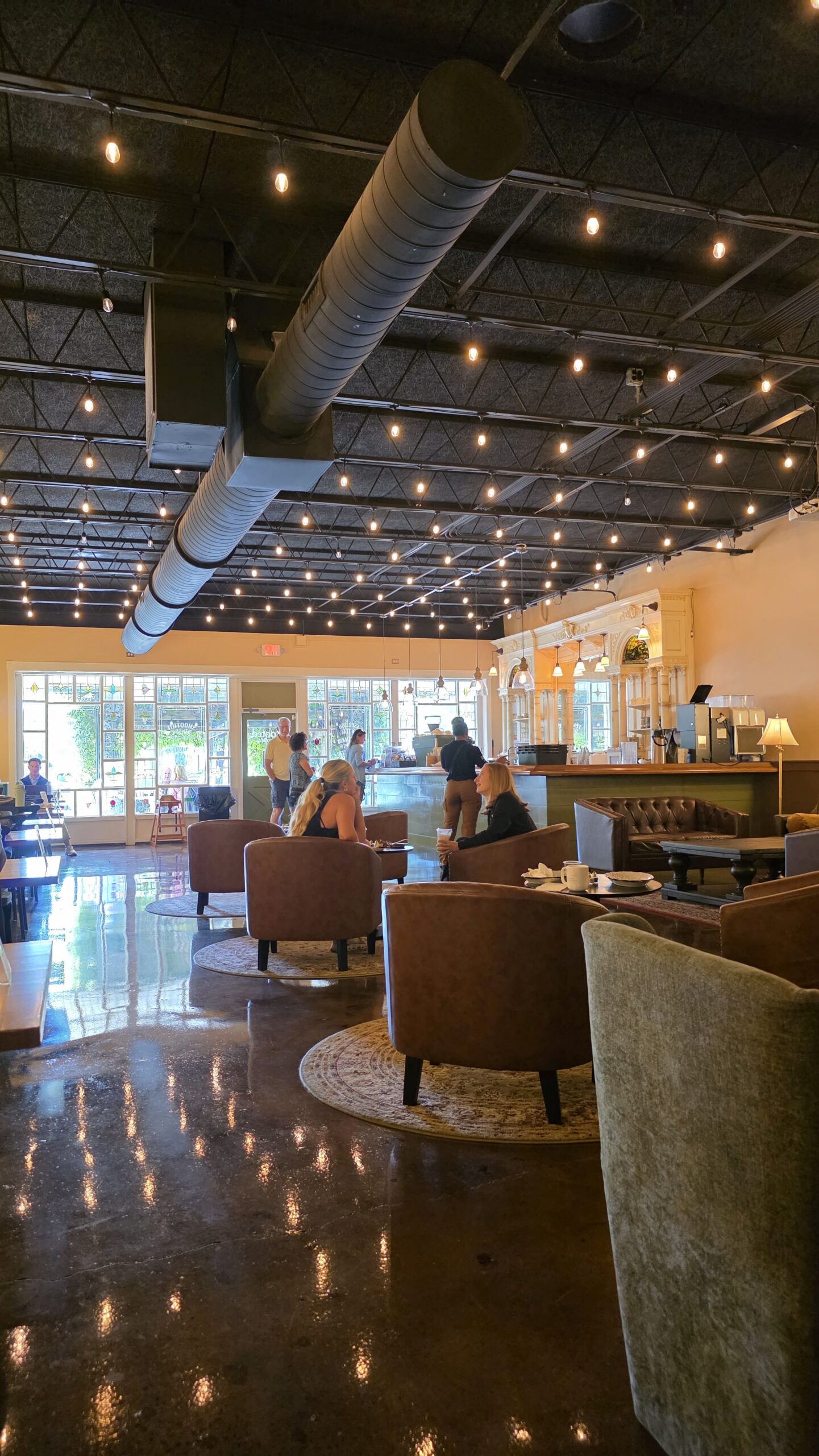 Open lounge seating and coffee counter inside Goat Kick Coffee
