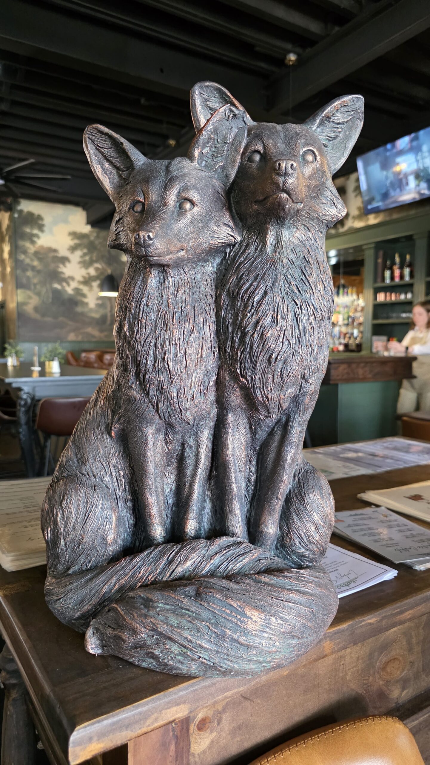Bronze fox statues on the hostess stand at Lanky's on Laurens